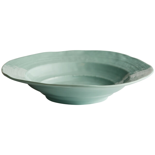 A close-up of an Elite Global Solutions Mint Green Della Terra serving bowl with a green rim.