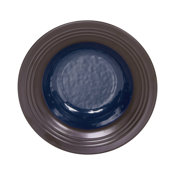 A Lapis blue bowl with a chocolate brown rim.