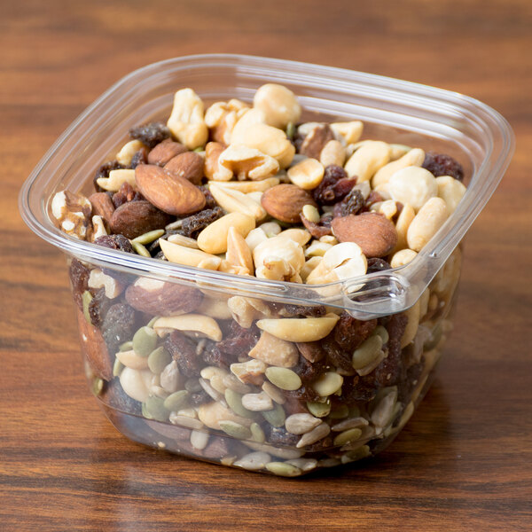 A 16 oz. square recycled PET deli container filled with nuts and raisins.