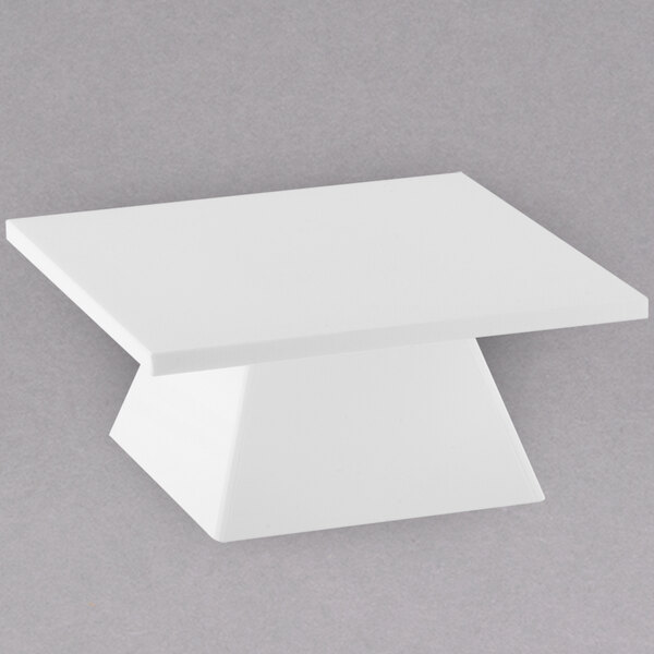 A white rectangular pedestal riser.