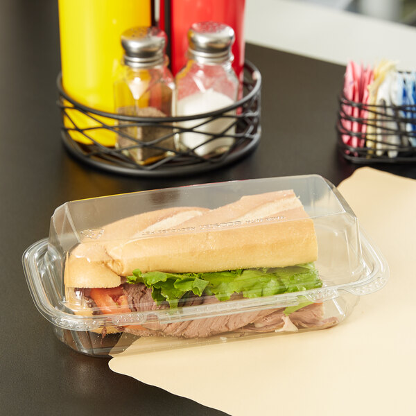 A hoagie in a 9" x 5" x 3" clear plastic takeout container.