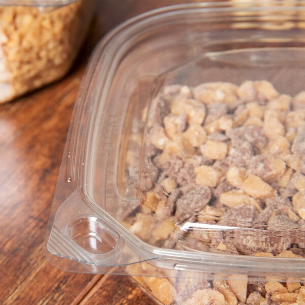 A Square Recycled PET deli container lid on a plastic container with food in it.