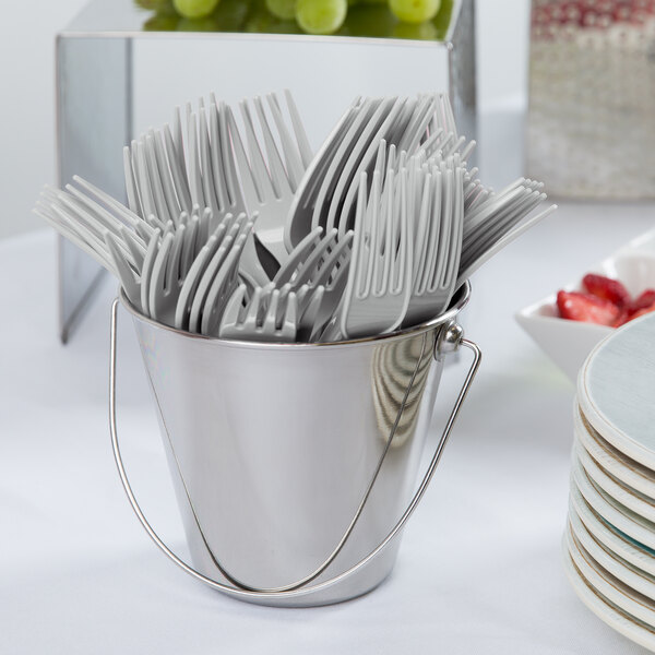 A bucket of Creative Converting Shimmering Silver plastic forks.