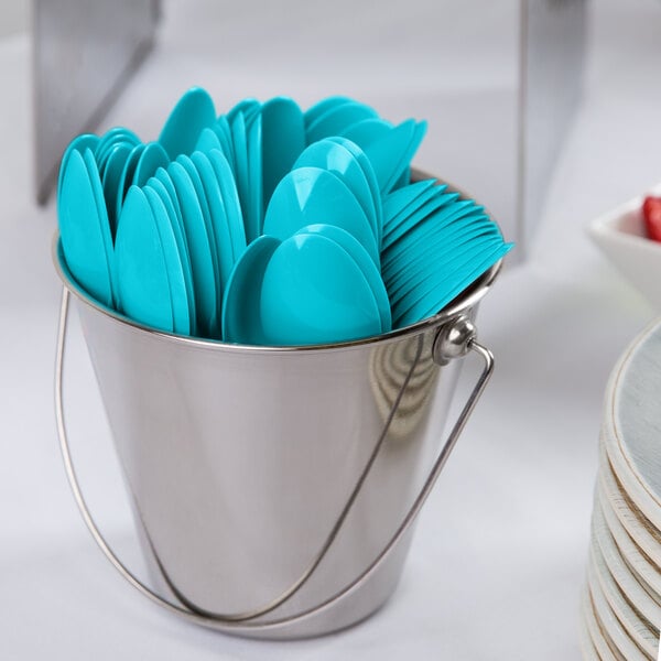 A bucket filled with Creative Converting Bermuda Blue plastic spoons.