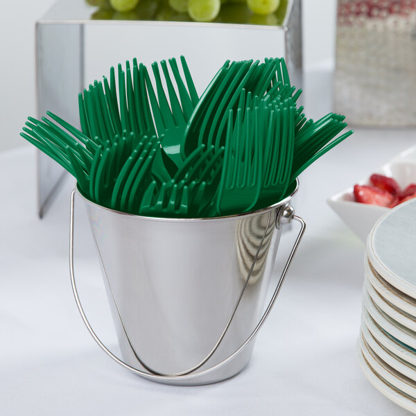 A white bucket filled with emerald green Creative Converting plastic forks.