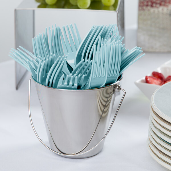 A bucket of blue plastic forks.