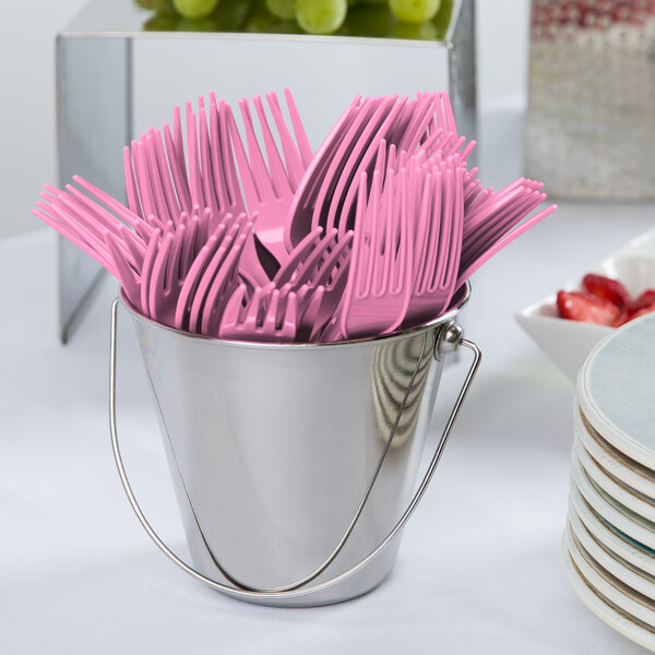 A bucket of Creative Converting pink plastic forks.