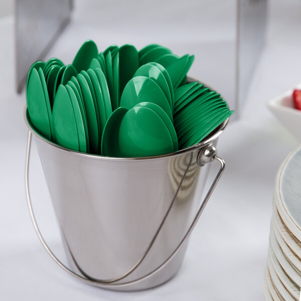 A bucket filled with emerald green plastic spoons.