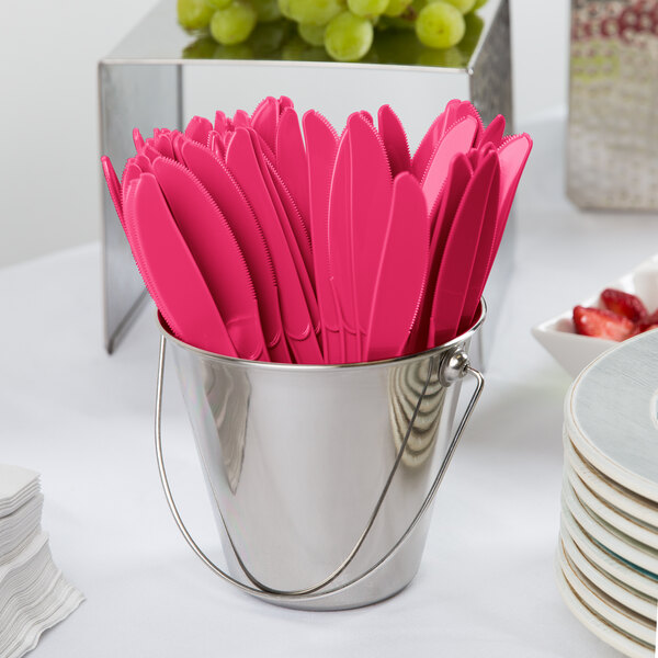 A bucket of Creative Converting Hot Magenta Pink plastic knives.
