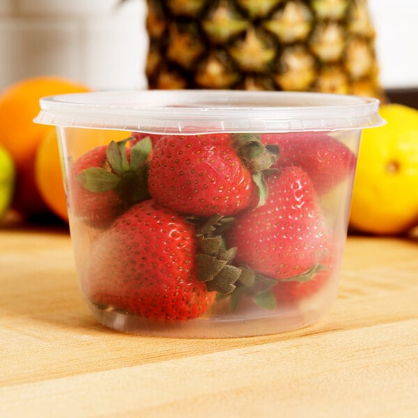 A Choice clear plastic container filled with strawberries.