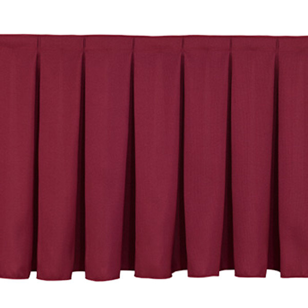 A burgundy National Public Seating box stage skirt with pleats on it.