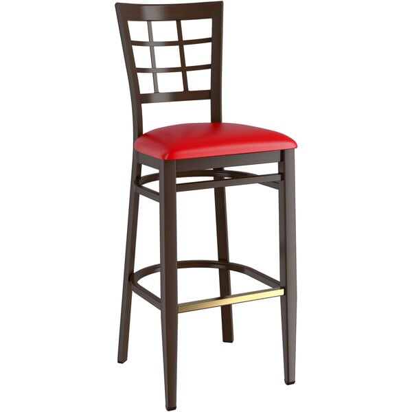 A Lancaster Table & Seating metal bar stool with red vinyl seat and window back.