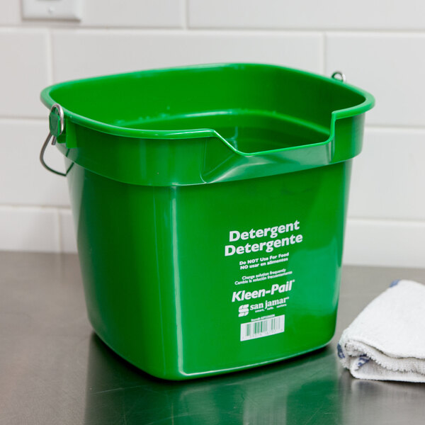 A green San Jamar Kleen-Pail with white text on it.