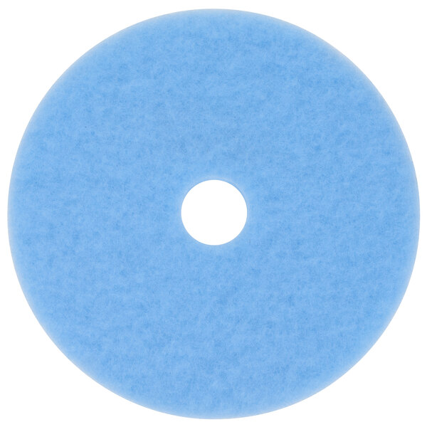 A sky blue 3M burnishing pad with a white circle in the middle.