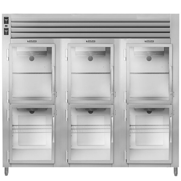 A Traulsen three section reach in heated holding cabinet with glass doors.