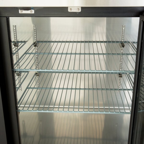 A metal middle shelf for an Avantco back bar refrigerator.