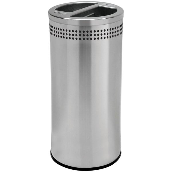 A close-up of a silver stainless steel round trash and recycling receptacle with a round top and holes in it.