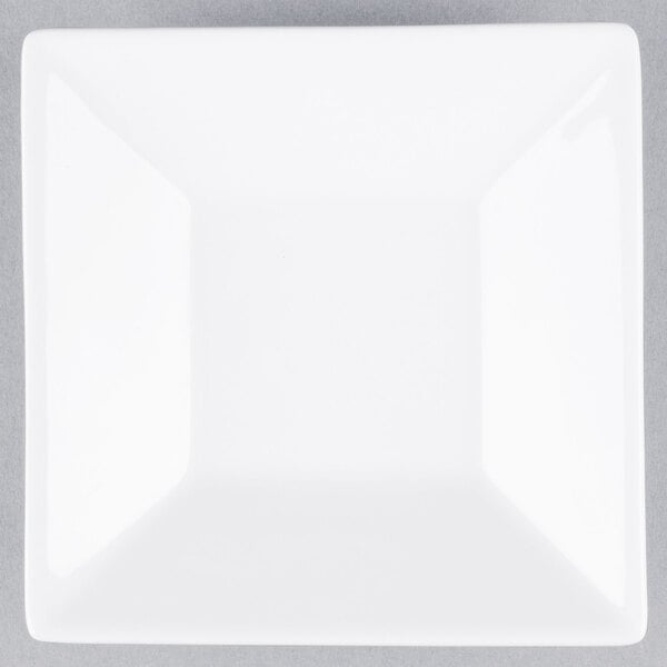 A white square Libbey porcelain saucer with a well ring.