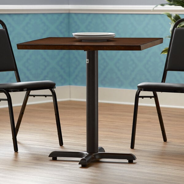 A FLAT Tech black table base with a table and two chairs.