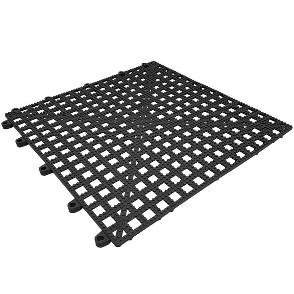 A black plastic grid floor mat with holes.