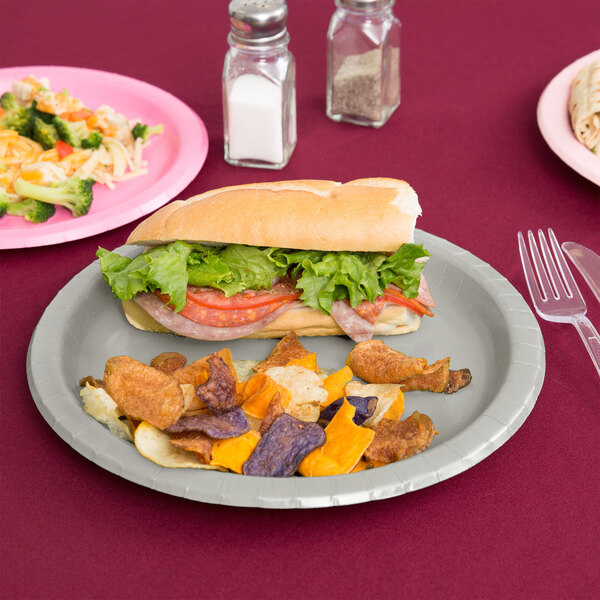 A sandwich on a Creative Converting shimmering silver paper plate.