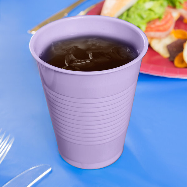 A Creative Converting Luscious Lavender purple plastic cup of liquid on a table