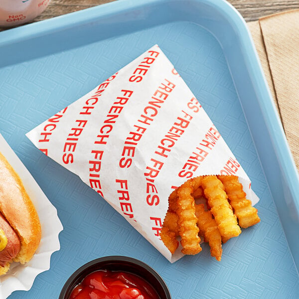 A white tray of Carnival King French fries and a hot dog with ketchup.