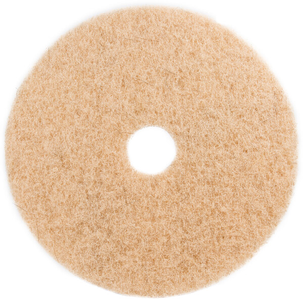 A white circular 3M Natural Blend tan floor pad with a hole in the middle.