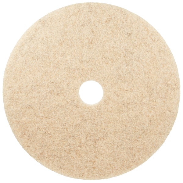 A white circular 3M Natural Blend tan burnishing floor pad with a hole in the center.