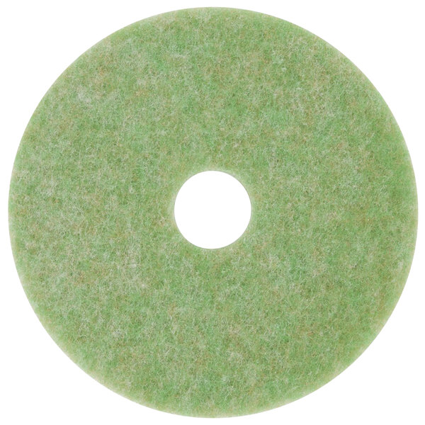 A white circle on a green circular 3M TopLine Autoscrubber floor pad.