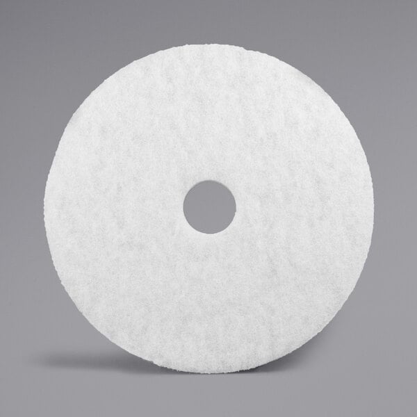 A 3M white circular floor pad.