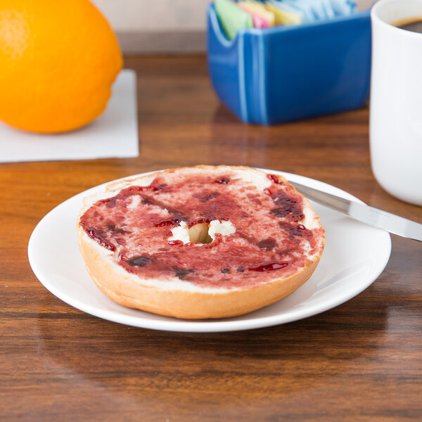 A bagel with jam on a Chef & Sommelier white bone china plate.