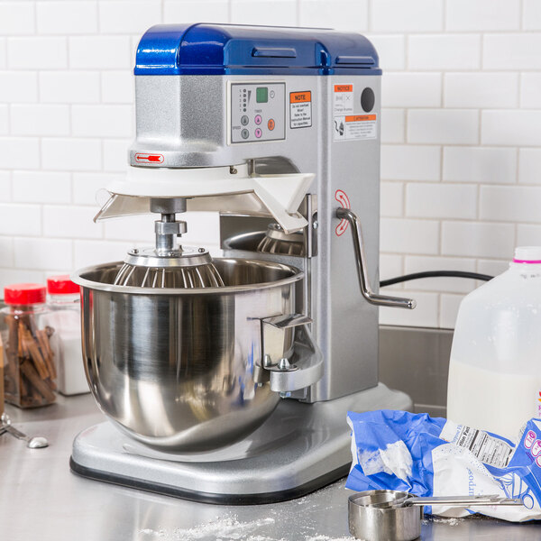 A Vollrath countertop mixer with a bowl and ingredients on a counter.