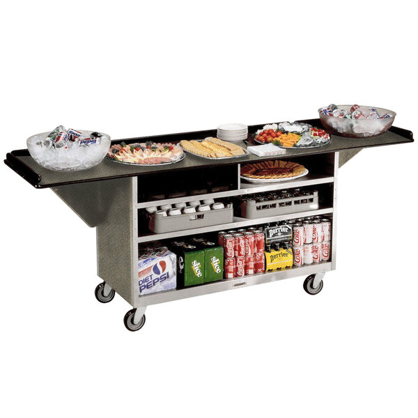 A Lakeside stainless steel beverage service cart with beige laminate shelves holding food and drinks.