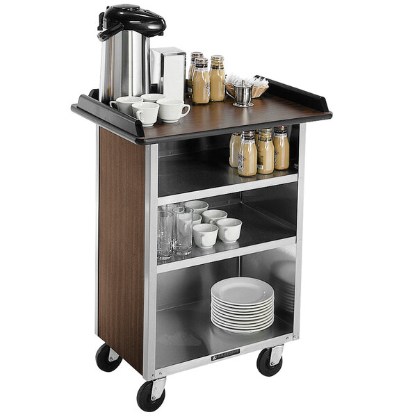 A Lakeside stainless steel beverage service cart with walnut vinyl shelves holding cups.