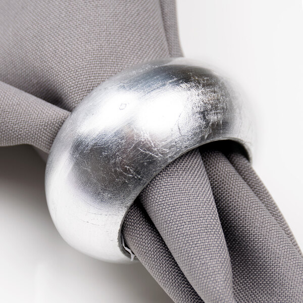 An American Atelier silver round acrylic napkin ring on a napkin.