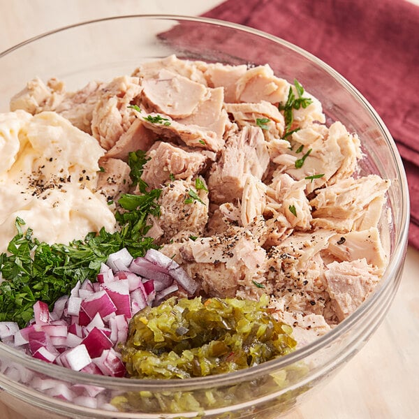 A bowl of Celebrity Chunk White Albacore Tuna salad on a table.