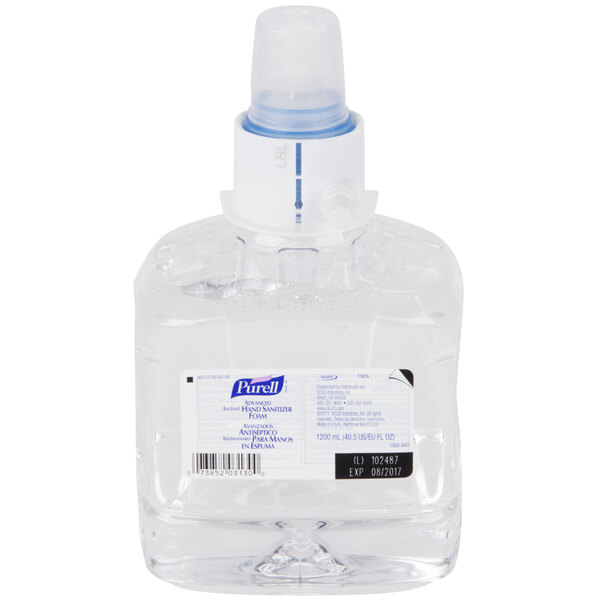 A Purell plastic bottle of foaming hand sanitizer with a blue cap.