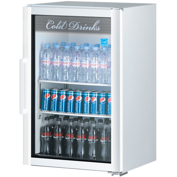 A white Turbo Air countertop display refrigerator with bottles of soda and water.
