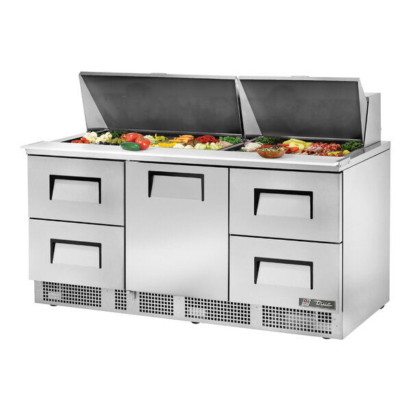 A stainless steel True refrigerated sandwich prep table with a drawer open.