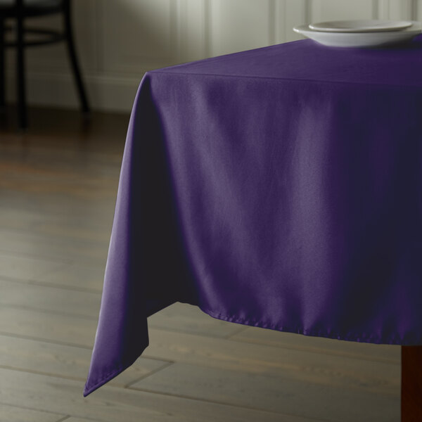 A purple Intedge square tablecloth on a table.