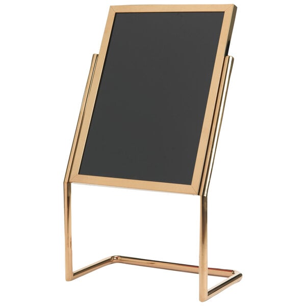 A black board on a brass double pedestal stand with gold accents.