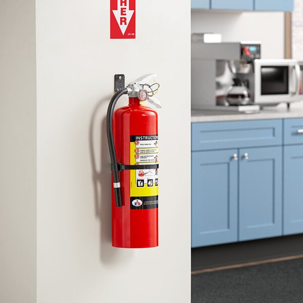 A Badger Advantage ABC fire extinguisher mounted on a wall.