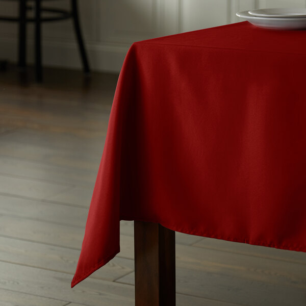 A rectangular red Intedge table cover on a table.