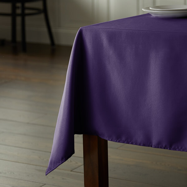 A square purple Intedge table cover on a table.