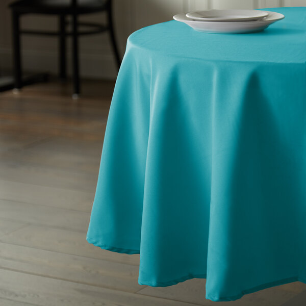 An Intedge teal round table cover on a table.