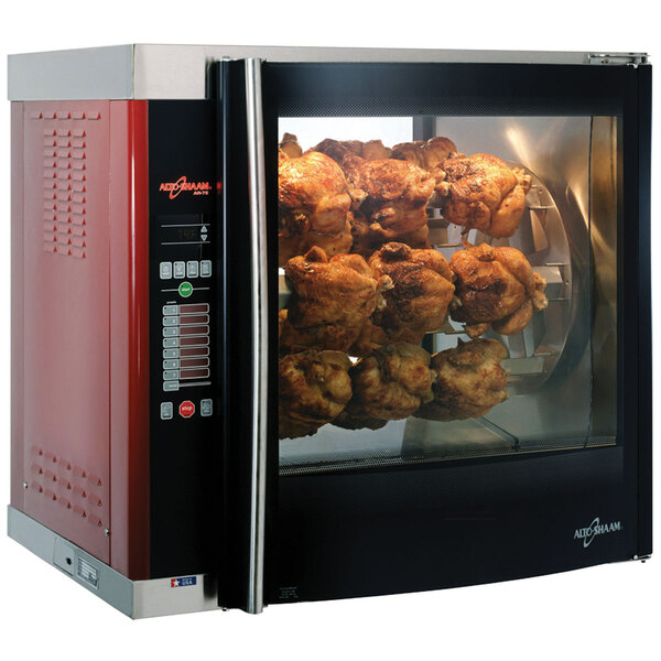 A large Alto-Shaam rotisserie oven with cooked chicken on the spits.