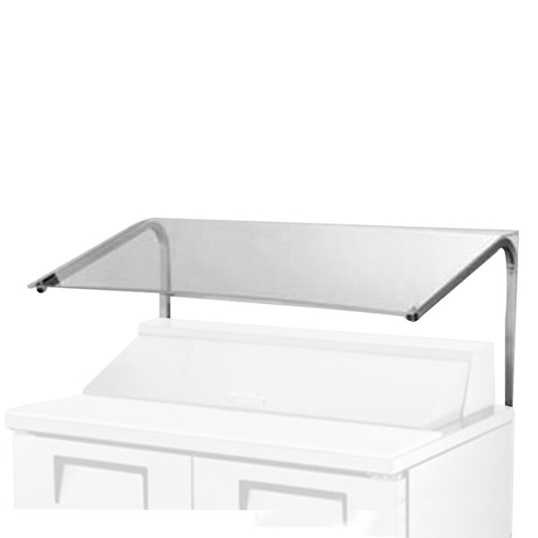 A white rectangular object on a white counter with a clear cover over it.