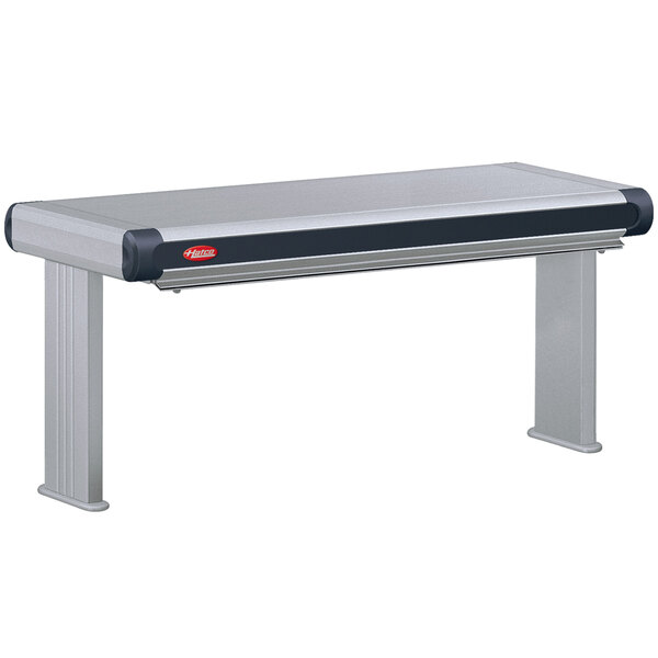 A Hatco Glo-Ray Designer infrared strip warmer on a stainless steel table with a black top.