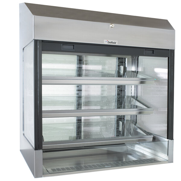 A Delfield stainless steel refrigerated glass display case with three shelves.